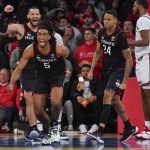 
              Connecticut's Isaiah Whaley (5), second from left, reacts after being fouled on his way to the basket during the second half of an NCAA college basketball game against St. John's, Sunday, Feb. 13, 2022, in New York. (AP Photo/Seth Wenig)
            