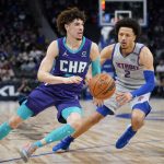 
              Charlotte Hornets guard LaMelo Ball (2) drives on Detroit Pistons guard Cade Cunningham (2) in the first half of an NBA basketball game in Detroit, Friday, Feb. 11, 2022. (AP Photo/Paul Sancya)
            