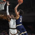 
              Notre Dame guard Prentiss Hubb (3) goes up for a shot against Miami forward Anthony Walker (1) during the first half of an NCAA college basketball game, Wednesday, Feb. 2, 2022, in Coral Gables, Fla. (AP Photo/Wilfredo Lee)
            