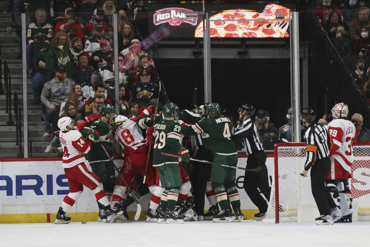 Minnesota Wild and Detroit Red Wings players scuffle during the second period of an NHL hockey game...