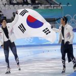 
              South Koreans Cha Min-kyu, left, and Kim Junho, carry their country's flag after the men's speedskating 500-meter race at the 2022 Winter Olympics, Saturday, Feb. 12, 2022, in Beijing. Cha won the silver medal. (AP Photo/Sue Ogrocki)
            