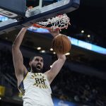 
              Indiana Pacers' Goga Bitadze dunks during the second half of an NBA basketball game against the Minnesota Timberwolves, Sunday, Feb. 13, 2022, in Indianapolis. (AP Photo/Darron Cummings)
            