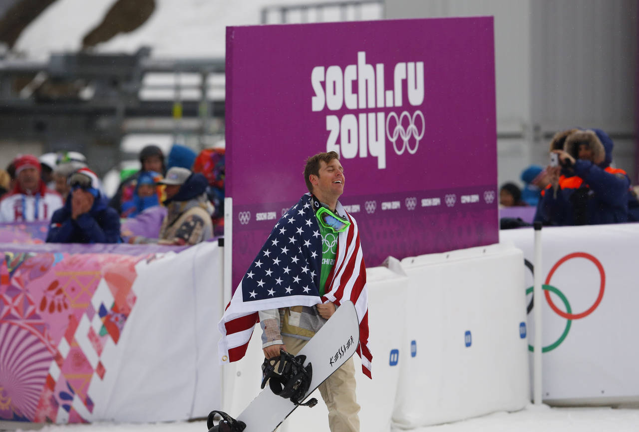 FILE - Bronze medalist Alex Deibold of the United States walks to a flower ceremony after the men's...