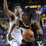 
              Purdue guard Jaden Ivey, right, goes to the basket against Michigan guard Eli Brooks during the first half of an NCAA college basketball game Thursday, Feb. 10, 2022, in Ann Arbor, Mich. (AP Photo/Duane Burleson)
            