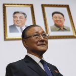 
              FILE - Under the portraits of the late North Korean leaders, Kim Il Sung, left, and Kim Jong Il, then North Korean Ambassador to China Ji Jae-Ryong arrives for a press conference at the North Korean Embassy in Beijing, Monday, May 15, 2017. The isolationist Communist state has sealed off its borders so tightly that they've left their own ambassador to China stranded in Beijing. Ji Jae-Ryong, 79, has been apart from his family for years even though his replacement arrived last February, two sources familiar with the matter say. (AP Photo/Andy Wong, File)
            