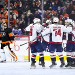 
              Washington Capitals' T.J. Oshie, right, celebrates with teammates after scoring a goal past Philadelphia Flyers goaltender Carter Hart, left, during the second period of an NHL hockey game, Saturday, Feb. 26, 2022, in Philadelphia. (AP Photo/Derik Hamilton)
            