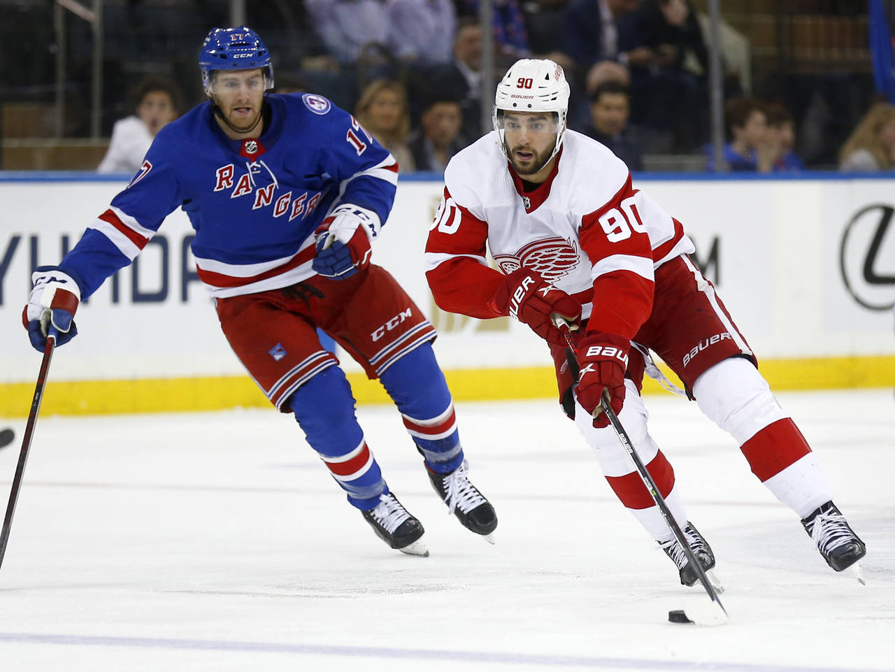 Detroit Red Wings' Joe Veleno (90) skates up ice while being pursued by New York Rangers Kevin Roon...