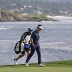 
              Beau Hossler walks up to the 18th green of the Pebble Beach Golf Links during the third round of the AT&T Pebble Beach Pro-Am golf tournament in Pebble Beach, Calif., Saturday, Feb. 5, 2022. (AP Photo/Eric Risberg)
            