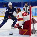 
              United States' Brian Oneill (21) watches as China goalkeeper Jieruimi Shimisi (Jeremy Smith) (45) deflects a shot during a preliminary round men's hockey game at the 2022 Winter Olympics, Thursday, Feb. 10, 2022, in Beijing. (AP Photo/Matt Slocum)
            