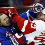 
              New York Rangers' Jacob Trouba (8) and Detroit Red Wings' Moritz Seider (53) scuffle during the first period of an NHL hockey game Thursday, Feb. 17, 2022, in New York. (AP Photo/John Munson)
            