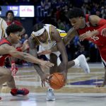 
              Mississippi guard Matthew Murrell (11), left, LSU forward Tari Eason (13) and Mississippi forward Luis Rodriguez (15) scramble for the ball during the second half of an NCAA college basketball game in Baton Rouge, La., Tuesday, Feb. 1, 2022. (AP Photo/Matthew Hinton)
            