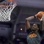 
              Oklahoma State forward Kalib Boone (22) leaps through the air for a slam dunk in the first half of an NCAA college basketball game against TCU in Fort Worth, Texas, Tuesday, Feb. 8, 2022. (AP Photo/Emil Lippe)
            