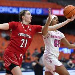 
              Louisville forward Emily Engstler, left, reaches for a rebound against Syracuse guard Alaina Rice during the second half of an NCAA college basketball game in Syracuse, N.Y., Sunday, Feb. 6, 2022. Louisville won 100-64. (AP Photo/Adrian Kraus)
            