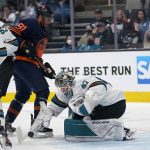 
              San Jose Sharks goaltender James Reimer, bottom, reaches for the puck under Edmonton Oilers left wing Evander Kane during the second period of an NHL hockey game in San Jose, Calif., Monday, Feb. 14, 2022. (AP Photo/Jeff Chiu)
            