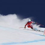 
              Corinne Suter, of Switzerland makes a turn during the women's downhill at the 2022 Winter Olympics, Tuesday, Feb. 15, 2022, in the Yanqing district of Beijing. (AP Photo/Alessandro Trovati)
            