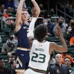 
              Notre Dame guard Dane Goodwin takes a shot against Miami guard Kameron McGusty (23) during the first half of an NCAA college basketball game, Wednesday, Feb. 2, 2022, in Coral Gables, Fla. (AP Photo/Wilfredo Lee)
            