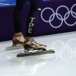 
              FILE - Huang Yu-ting, of Taiwan, wears golden skates as she passes the Olympic rings when skating laps prior to the women's 1,500 meters speedskating race at the Gangneung Oval at the 2018 Winter Olympics in Gangneung, South Korea, Feb. 12, 2018. The four Taiwanese athletes competing in Beijing for the Winter Olympics, which open Friday, Feb. 4, 2022, can’t use Taiwan’s flag and have long competed under a name, Chinese Taipei. (AP Photo/Petr David Josek, File)
            