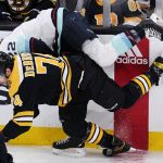 
              Boston Bruins left wing Jake DeBrusk (74) checks Seattle Kraken center Mason Appleton, rear, during the first period of an NHL hockey game, Tuesday, Feb. 1, 2022, in Boston. (AP Photo/Charles Krupa)
            