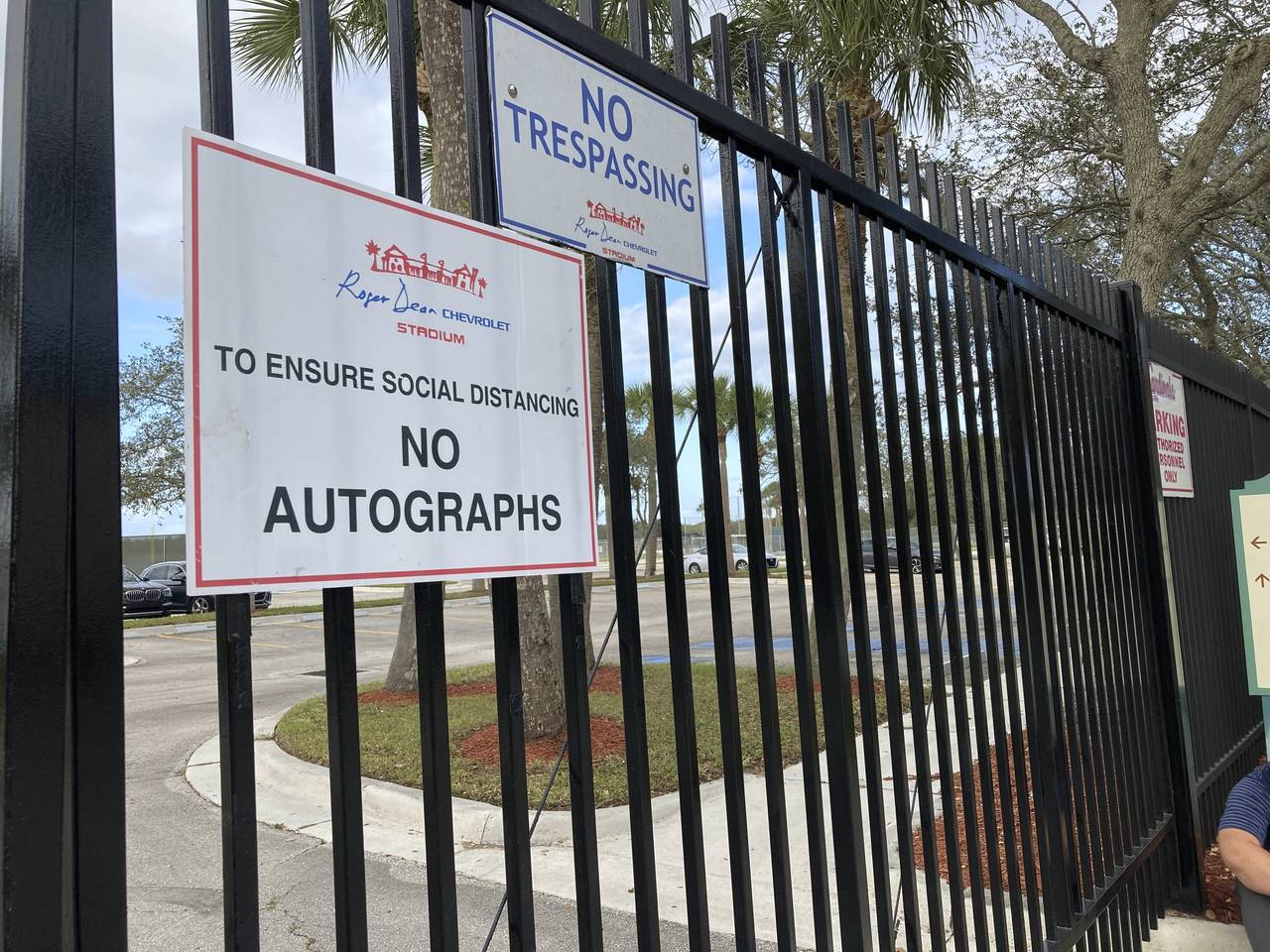 Signs are posted outside Roger Dean Stadium in Jupiter, Fla., Monday, Feb. 21, 2022. Baseball labor...