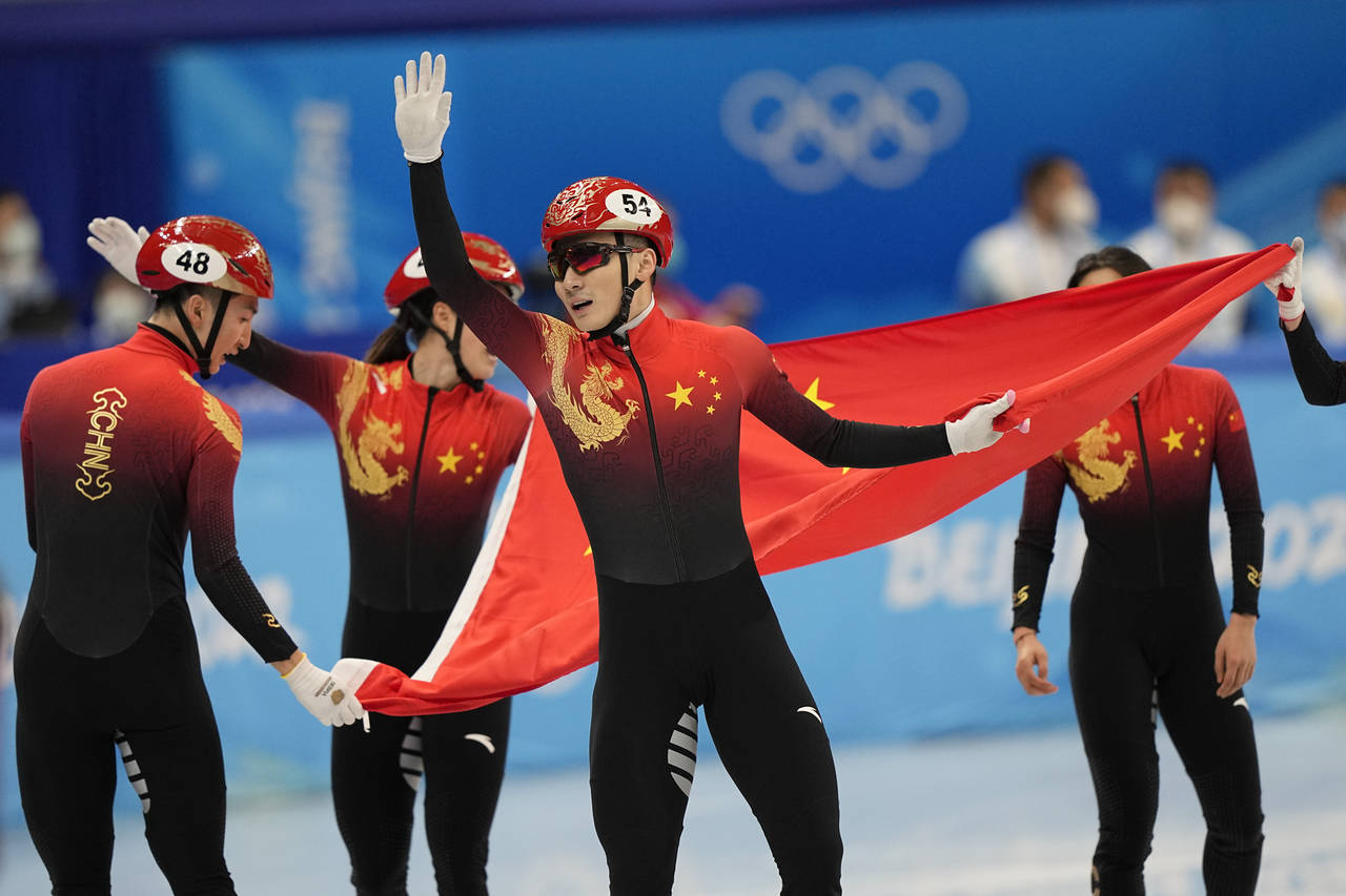 Ren Ziwei of China celebrates with teammates after they won the mixed team relay final during the s...