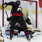 
              Ottawa Senators right wing Connor Brown looks for the rebound as Boston Bruins goaltender Jeremy Swayman makes a save during the second period of an NHL hockey game Saturday, Feb. 18, 2022 in Ottawa, Ontario. (Adrian Wyld/The Canadian Press via AP)
            