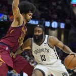 
              Brooklyn Nets' James Harden (13) drives past Cleveland Cavaliers' Jarrett Allen (31) in the second half of an NBA basketball game, Monday, Jan. 17, 2022, in Cleveland. (AP Photo/Tony Dejak)
            
