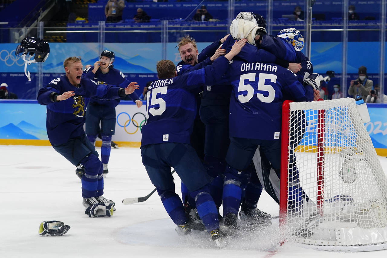 Finland players celebrate after beating Russian Olympic Committee to win the men's gold medal hocke...