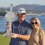 
              Tom Hoge, left, poses with his trophy and his wife, Kelly, on the 18th green of the Pebble Beach Golf Links after winning the AT&T Pebble Beach Pro-Am golf tournament in Pebble Beach, Calif., Sunday, Feb. 6, 2022. (AP Photo/Eric Risberg)
            