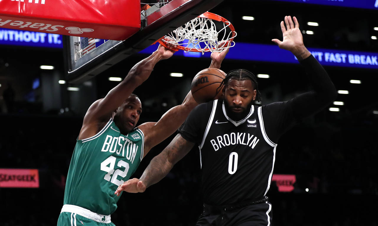 Boston Celtics center Al Horford (42) dunks against Brooklyn Nets center Andre Drummond (0) during ...