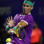 
              Rafael Nadal of Spain returns a ball to Tommy Paul of the U.S. during the quarterfinal match of the Mexican Open tennis tournament in Acapulco, Mexico, Thursday, Feb. 24, 2022. (AP Photo/Eduardo Verdugo)
            