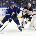 
              Tampa Bay Lightning center Brayden Point (21) looks to pass after getting around Edmonton Oilers center Connor McDavid (97) during the second period of an NHL hockey game Wednesday, Feb. 23, 2022, in Tampa, Fla. (AP Photo/Chris O'Meara)
            