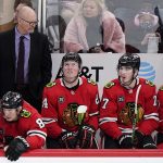 
              Chicago Blackhawks interim head coach Derek King, top left, looks on during the third period of an NHL hockey game against the Columbus Blue Jackets in Chicago, Thursday, Feb. 17, 2022. (AP Photo/Nam Y. Huh)
            