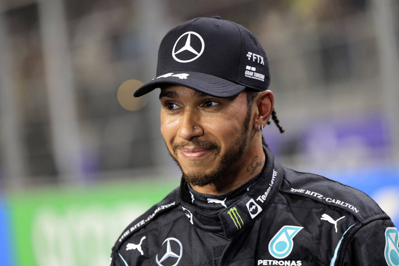 FILE- Mercedes driver Lewis Hamilton, of Britain smiles, after winning the pole position during qua...