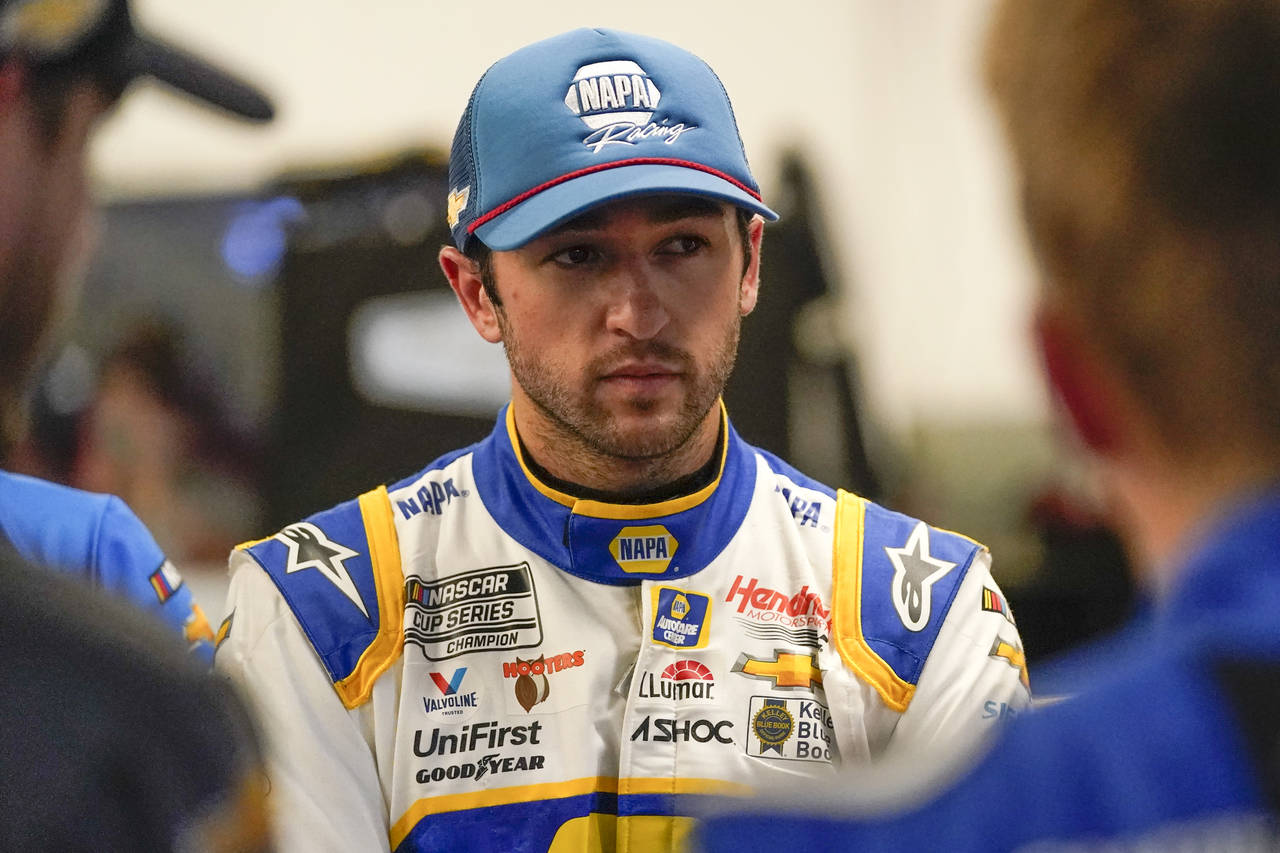 Chase Elliott talks with team members in the garage during NASCAR Daytona 500 auto race practice at...