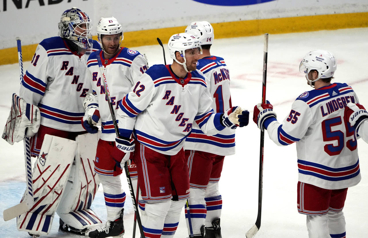 New York Rangers celebrate their win over the Ottawa Senators during third-period NHL hockey game a...