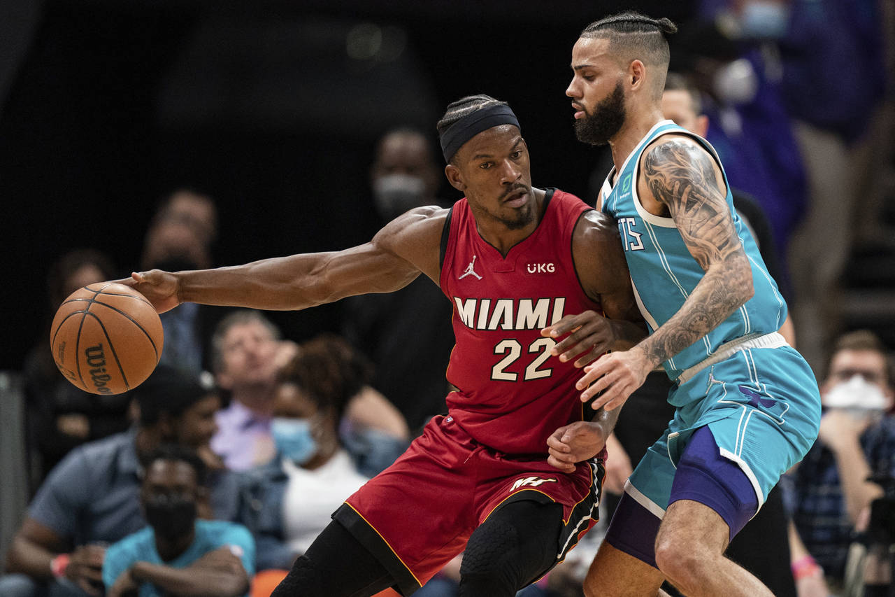 Charlotte Hornets forward Cody Martin (11) guards Miami Heat forward Jimmy Butler (22) during the f...