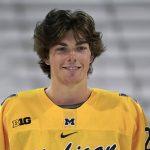 
              FILE- University of Michigan defenseman Owen Power smiles during an NCAA college hockey practice in Ann Arbor, Mich., Wednesday, Sept. 22, 2021. With the NHL bowing out of Beijing, players like Power are at the Olympics. “We kind of got notice (the Olympics) may be a possibility when the NHL announced they weren’t going,” Power said. "I don’t want to say made up (for it), but it was kind of just nice knowing that we most likely have another opportunity to come play for Canada even though world juniors was over.” (AP Photo/Paul Sancya, File)
            