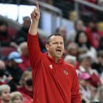 
              Louisville head coach Jeff Walz sends a play in to his team during the second half of an NCAA college basketball game against Notre Dame in Louisville, Ky., Sunday, Feb. 13, 2022. (AP Photo/Timothy D. Easley)
            