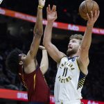 
              Indiana Pacers' Domantas Sabonis (11) shoots against Cleveland Cavaliers' Jarrett Allen (31) during the second half of an NBA basketball game, Sunday, Feb 6, 2022, in Cleveland. The Cavaliers defeated the Pacers 98-85. (AP Photo/Ron Schwane)
            