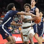 
              Virginia guard Reece Beekman (2) blocks Miami guard Kameron McGusty's (23) drive to the basket during the second half of an NCAA college basketball game, Saturday, Feb. 19, 2022, in Coral Gables, Fla. (AP Photo/Marta Lavandier)
            