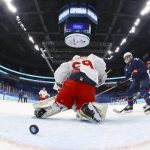 
              United States' Hilary Knight (21) scores a goal against Russian Olympic Committee goalkeeper Maria Sorokina (69) during a preliminary round women's hockey game at the 2022 Winter Olympics, Saturday, Feb. 5, 2022, in Beijing. (Brian Snyder/Pool Photo via AP)
            