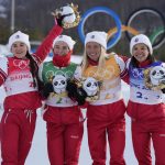 
              From left, Yulia Stupak, of the Russian Olympic Committee, Natalia Nepryaeva, Tatiana Sorina, and Veronika Stepanova celebrate after winning the gold medal during a venue ceremony after the women's 4 x 5km relay cross-country skiing competition at the 2022 Winter Olympics, Saturday, Feb. 12, 2022, in Zhangjiakou, China. (AP Photo/Aaron Favila)
            