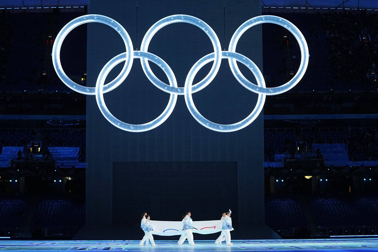 FILE - The Olympic flag is carried into the stadium during the opening ceremony of the 2022 Winter ...