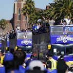 
              Buses carrying Los Angeles Rams players and coaches drive past fans during the team's victory parade in Los Angeles, Wednesday, Feb. 16, 2022, following their win Sunday over the Cincinnati Bengals in the NFL Super Bowl 56 football game. (AP Photo/Marcio Jose Sanchez)
            