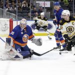 
              New York Islanders goaltender Ilya Sorokin (30) turns away a shot by Boston Bruins center Patrice Bergeron (37) during the first period of an NHL hockey game Thursday Feb. 17, 2022, in Elmont, N.Y. (AP Photo/Corey Sipkin).
            