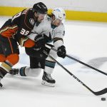 
              Anaheim Ducks center Sam Carrick (39) and San Jose Sharks left wing Alexander Barabanov (94) vie for the puck during the second period of an NHL hockey game Tuesday, Feb. 22, 2022, in Anaheim, Calif. (AP Photo/John McCoy)
            