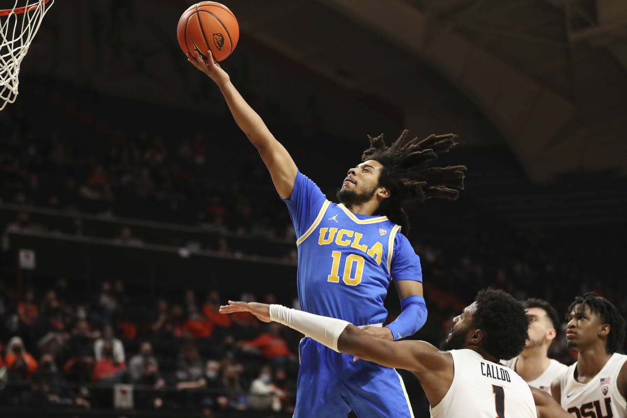 UCLA guard Tyger Campbell (10) drives to the basket past Oregon State forward Maurice Calloo (1) du...