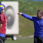 
              Los Angeles Rams head coach Sean McVay, right, gestures as quarterback Matthew Stafford stand by during practice for an NFL Super Bowl football game Friday, Feb. 11, 2022, in Thousand Oaks, Calif. The Rams are scheduled to play the Cincinnati Bengals in the Super Bowl on Sunday. (AP Photo/Mark J. Terrill)
            