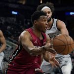 
              Miami Heat guard Kyle Lowry, center, drives around San Antonio Spurs guard Derrick White, right, during the first half of an NBA basketball game, Thursday, Feb. 3, 2022, in San Antonio. (AP Photo/Eric Gay)
            