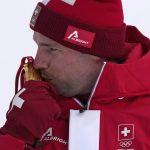 
              Beat Feuz, of Switzerland kisses his gold medal during the ceremony for the men's downhill at the 2022 Winter Olympics, Monday, Feb. 7, 2022, in the Yanqing district of Beijing. (AP Photo/Luca Bruno)
            